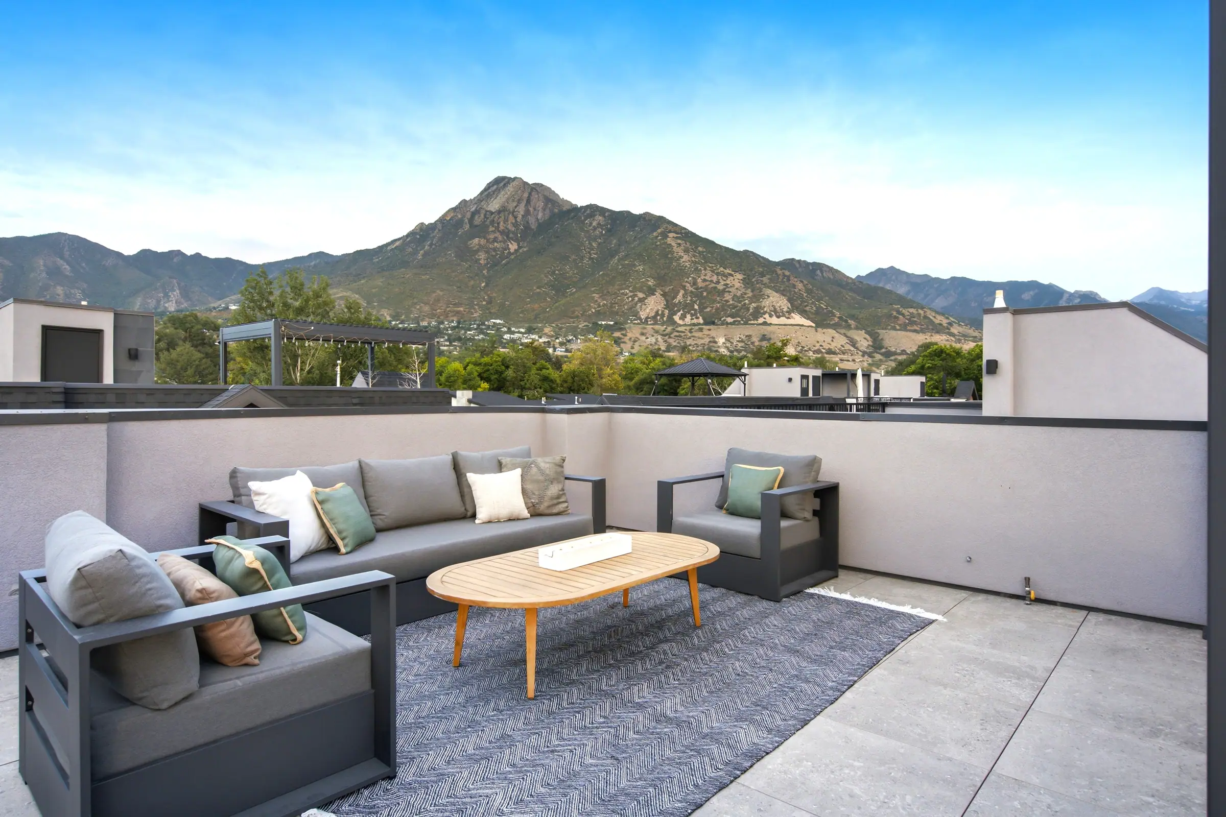 Rooftop lounge seating below Mount Olympus